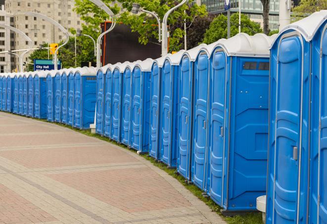 hygienic portable restrooms lined up at a beach party, ensuring guests have access to the necessary facilities while enjoying the sun and sand in Bloomfield